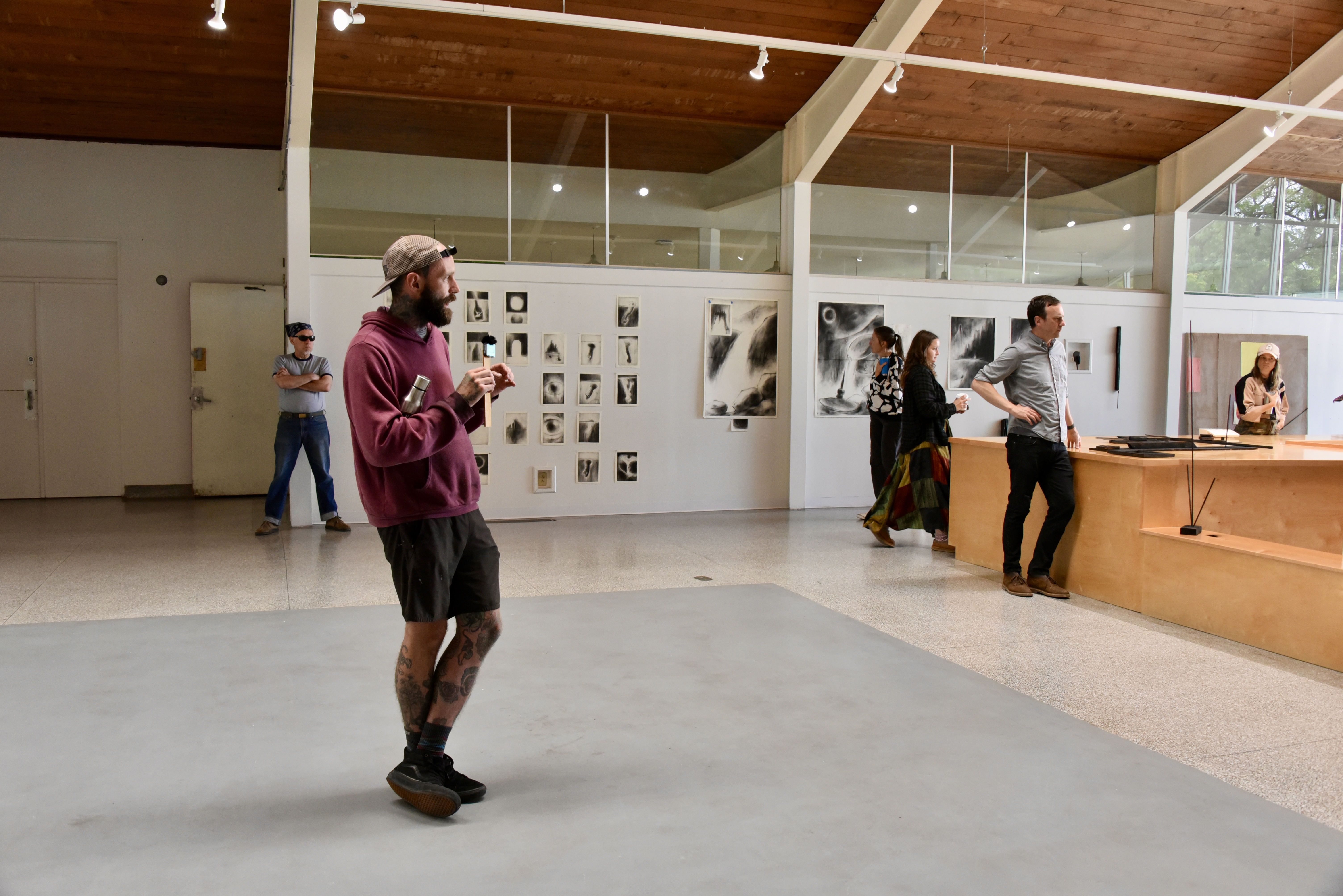 Visitors viewing artwork in a bright gallery space